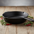 Pre-seasoned cast iron skillet side angle view on rustic wooden surface